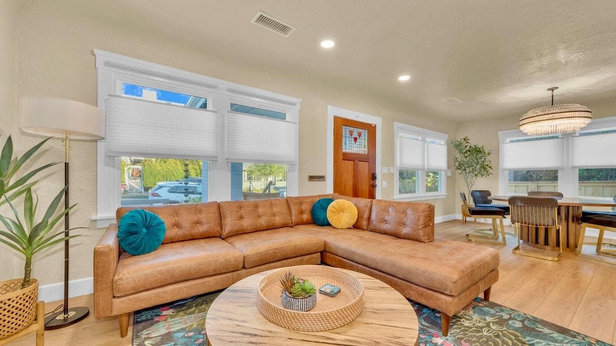 The living room features a large comfortable leather sofa 